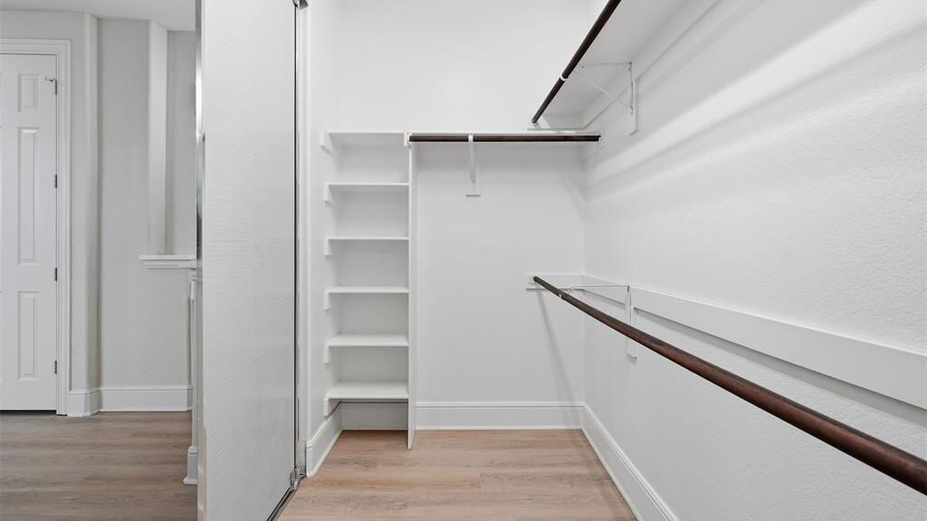 Primary closet as the listing supplied it, unfurnished